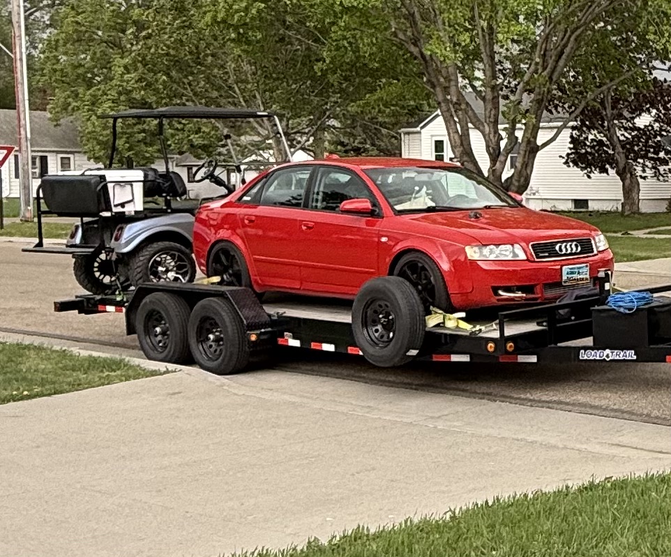 Car hauler trailer rental with red Audi loaded - professional vehicle transport in Fargo North Dakota