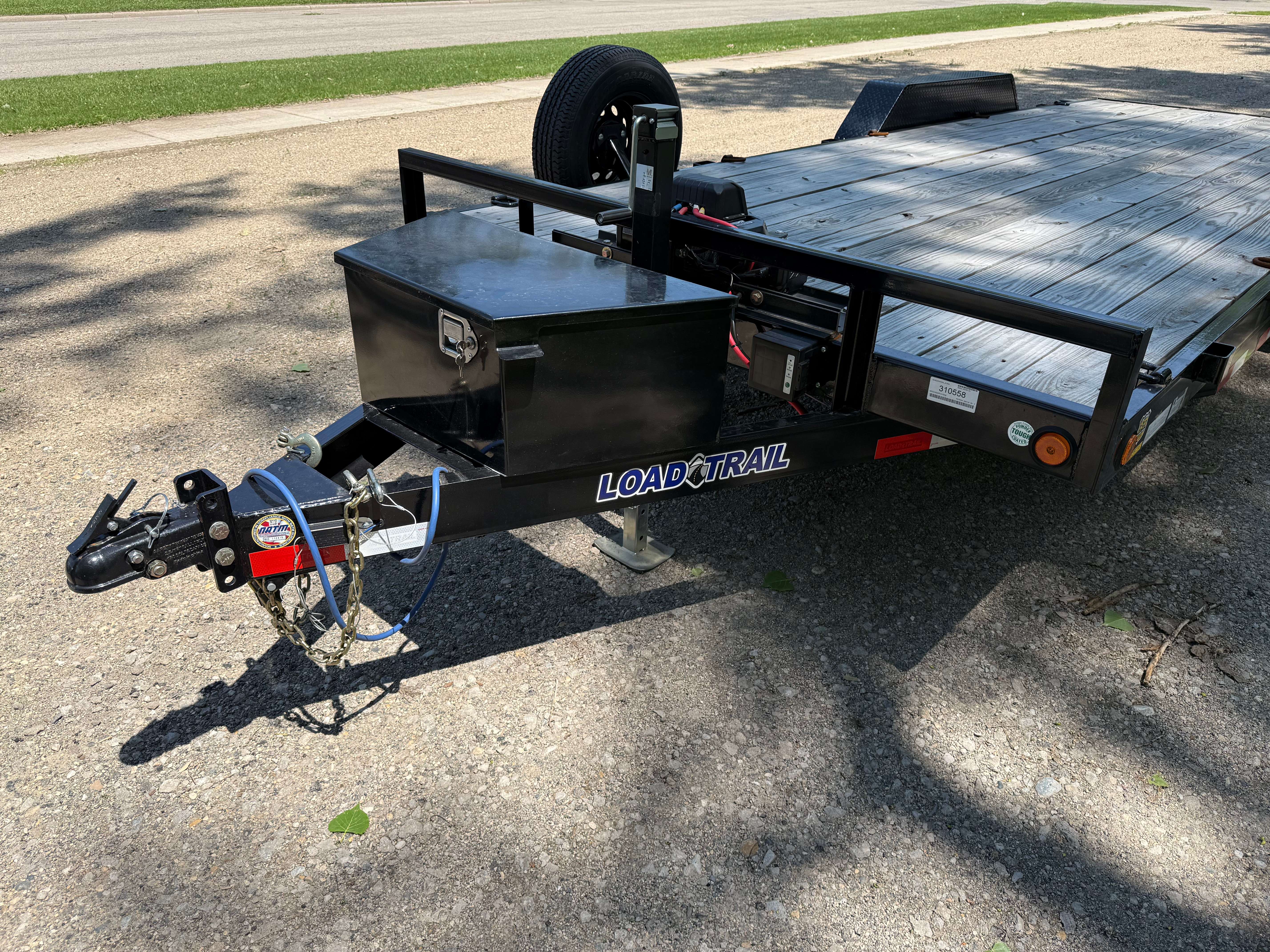 20ft Load Trail flatbed trailer - front view with hitch and toolbox